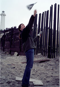 image of julia bradshaw flying paper planes across the US Mexican border